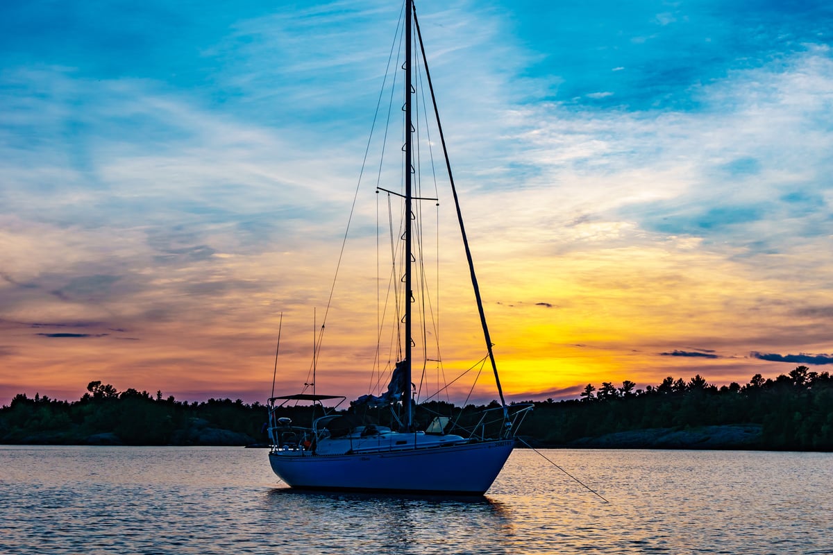 Blue Sailboat on Body of Water